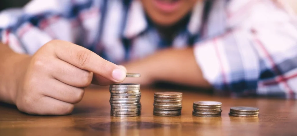 Person creating stacks of coins